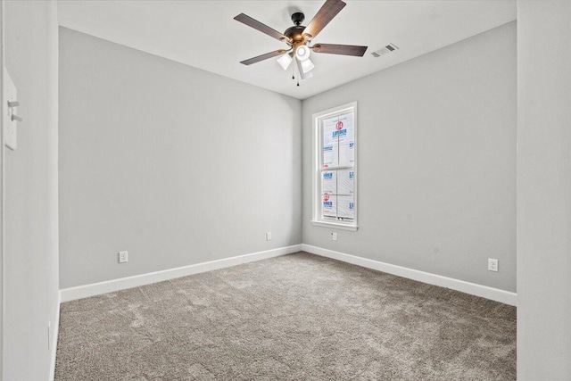 carpeted spare room featuring ceiling fan