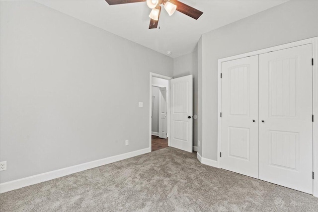 unfurnished bedroom with ceiling fan, a closet, and carpet flooring