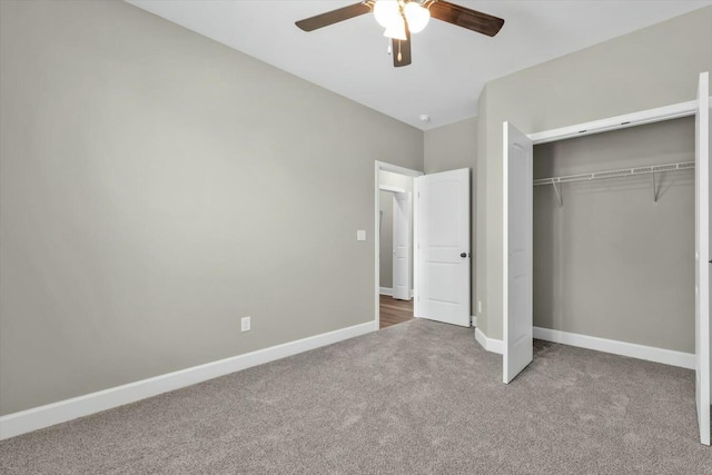 unfurnished bedroom with carpet floors, a closet, baseboards, and ceiling fan