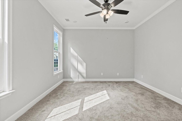 carpeted empty room with ceiling fan and ornamental molding