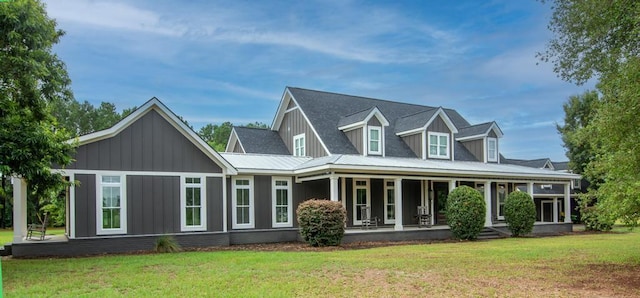 rear view of property with a yard