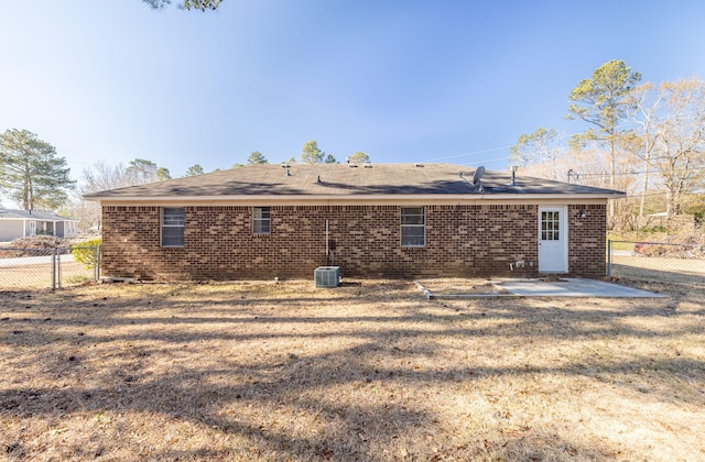 back of property featuring central AC, a yard, and a patio