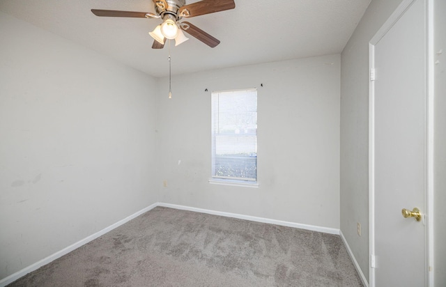 spare room with ceiling fan and light carpet