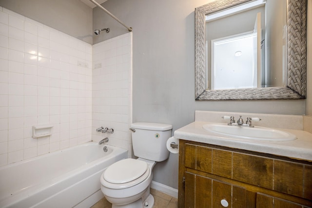 full bathroom with toilet, tile patterned floors, tiled shower / bath, and vanity