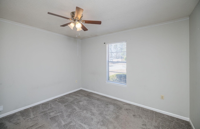 carpeted spare room with ceiling fan and a textured ceiling