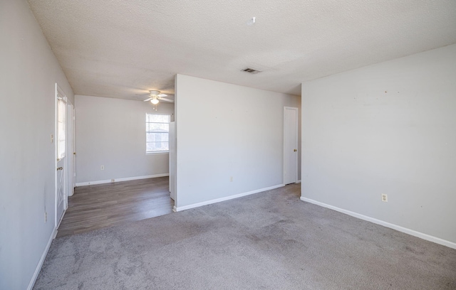 carpeted spare room featuring a textured ceiling