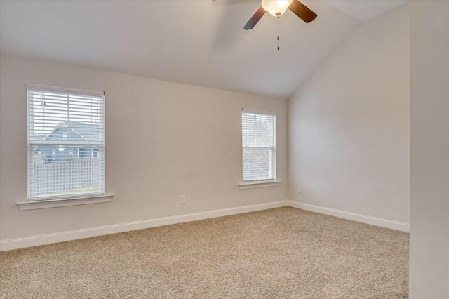 carpeted empty room with ceiling fan and vaulted ceiling