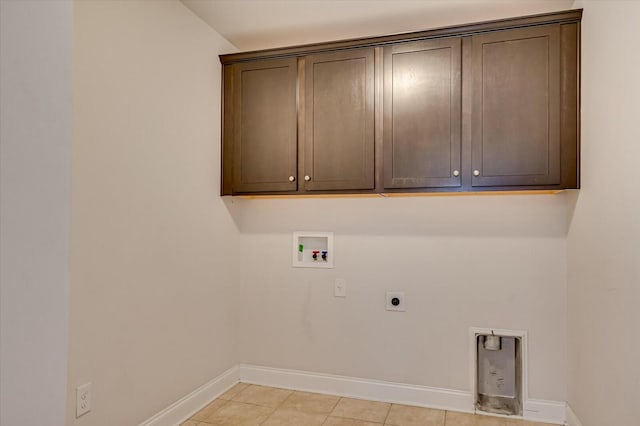 clothes washing area with cabinets, light tile patterned flooring, washer hookup, and hookup for an electric dryer