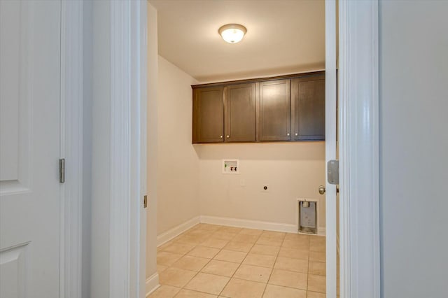 laundry area with cabinets, electric dryer hookup, hookup for a washing machine, and light tile patterned floors