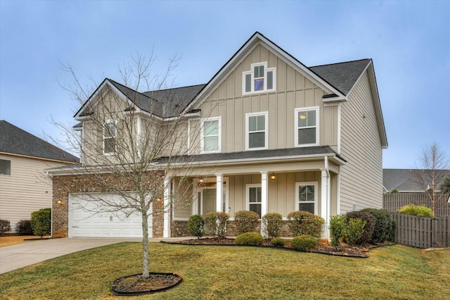 view of front facade with a garage, a front lawn, and a porch