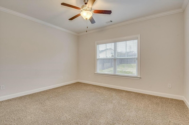 carpeted spare room featuring ceiling fan and ornamental molding