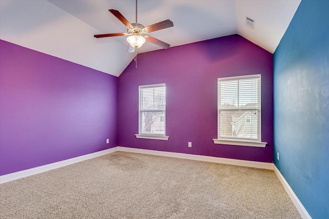 carpeted spare room featuring lofted ceiling and ceiling fan