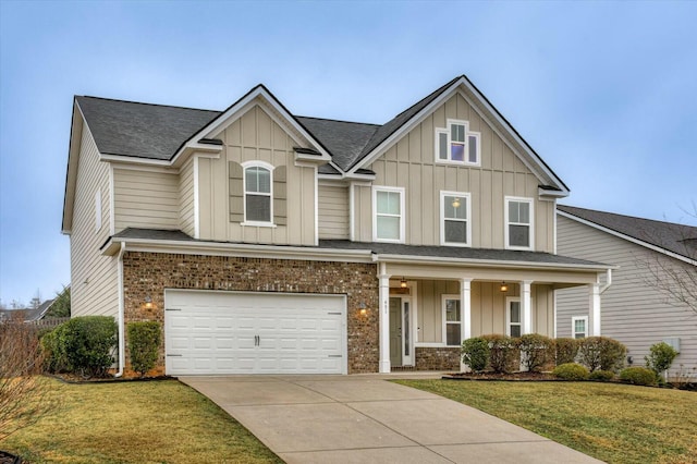 view of front facade featuring a garage, a porch, and a front lawn