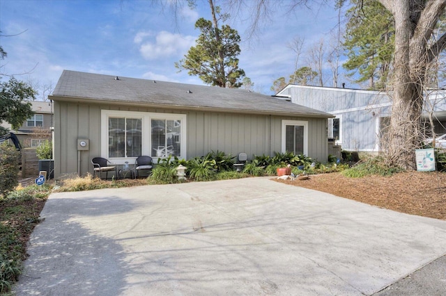 back of house with central AC unit