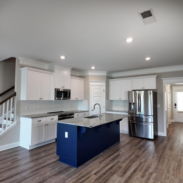 333 Sumac Trl, Evans, GA 30809 - kitchen with appliances with stainless steel finishes, crown molding, white cabinetry, a breakfast bar, and a kitchen island with sink