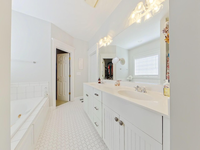 full bathroom with vanity, baseboards, and a whirlpool tub