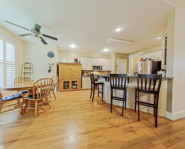 dining area featuring recessed lighting, a ceiling fan, light wood-type flooring, and baseboards