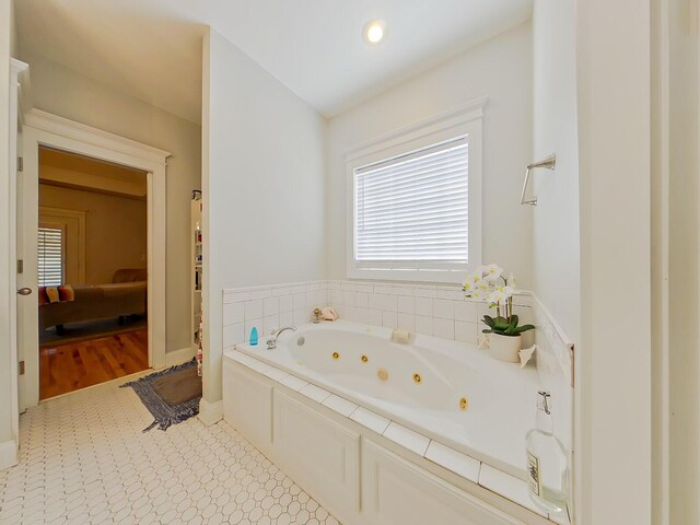 ensuite bathroom featuring a jetted tub and ensuite bathroom