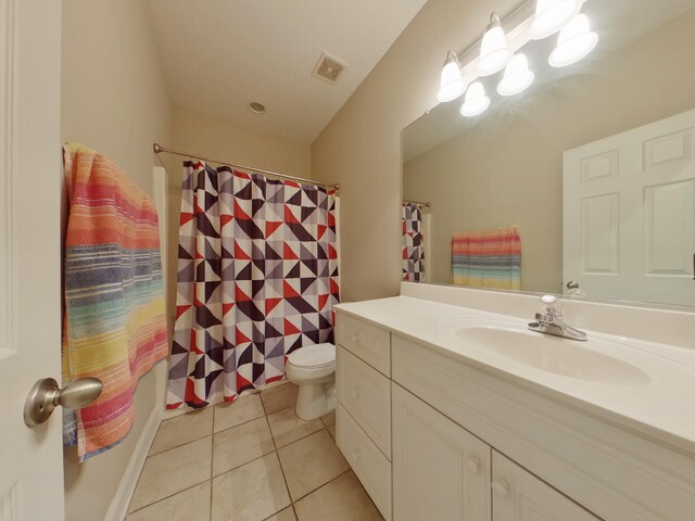 bathroom with visible vents, a shower with curtain, toilet, tile patterned flooring, and vanity