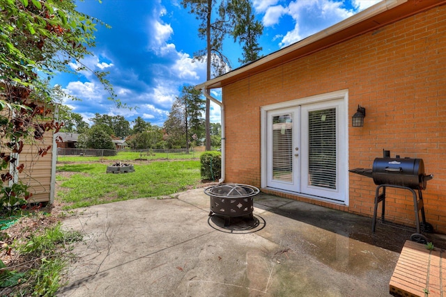 3414 Forest Estates Dr, Augusta, GA 30909 - fenced backyard featuring an outdoor fire pit, grilling area, a patio area, and french doors