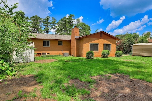 3414 Forest Estates Dr, Augusta, GA 30909 - rear view of house with a shed, a chimney, brick siding, and a yard