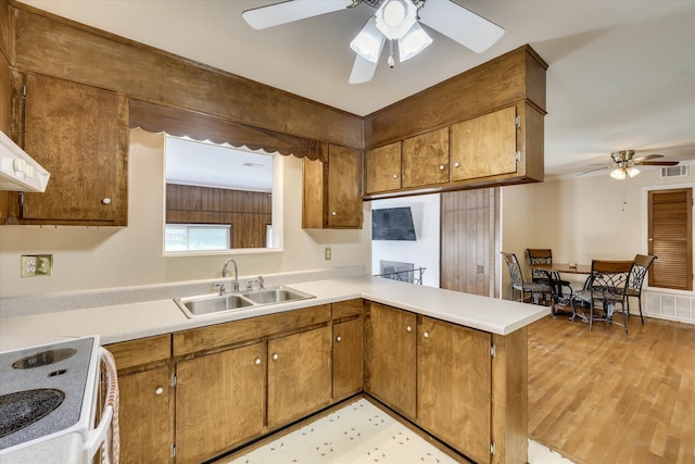 3414 Forest Estates Dr, Augusta, GA 30909 - kitchen featuring ceiling fan, light countertops, brown cabinetry, and a peninsula