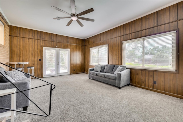 3414 Forest Estates Dr, Augusta, GA 30909 - living area featuring french doors, ornamental molding, ceiling fan, wood walls, and light carpet