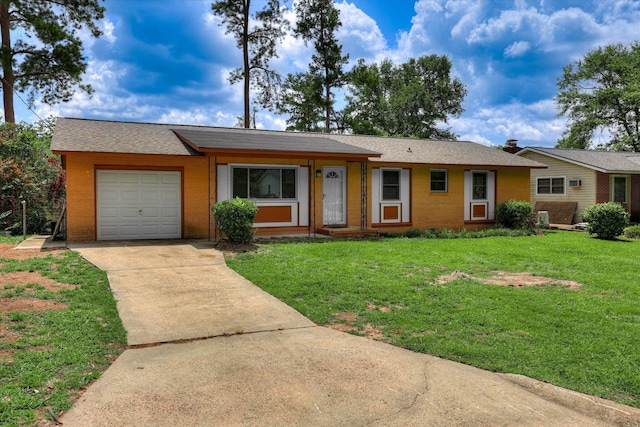 3414 Forest Estates Dr, Augusta, GA 30909 - ranch-style home featuring concrete driveway, an attached garage, a front yard, and brick siding