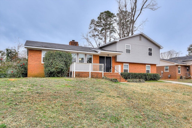 tri-level home with a front yard and a porch