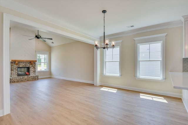 unfurnished living room featuring lofted ceiling, light wood-style flooring, baseboards, a fireplace, and ceiling fan with notable chandelier