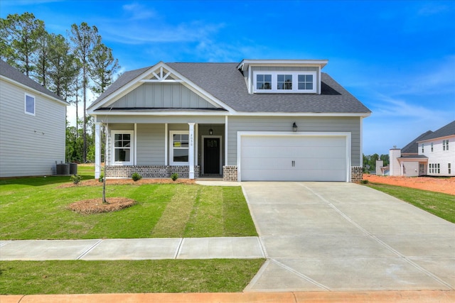 craftsman-style house featuring a porch, brick siding, a garage, driveway, and a front yard