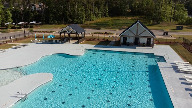 pool with a patio, a gazebo, and fence