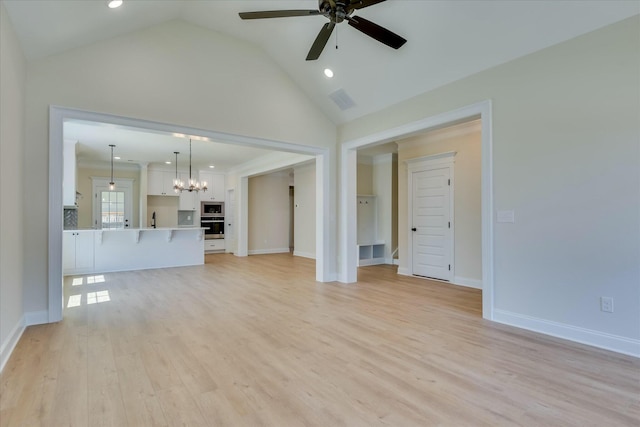unfurnished living room with recessed lighting, light wood-style floors, ceiling fan with notable chandelier, baseboards, and visible vents