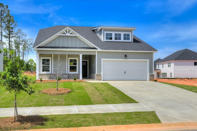 craftsman inspired home featuring a front lawn, driveway, a shingled roof, and brick siding