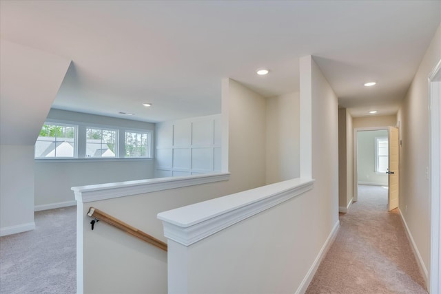 hallway featuring an upstairs landing, light colored carpet, recessed lighting, and baseboards