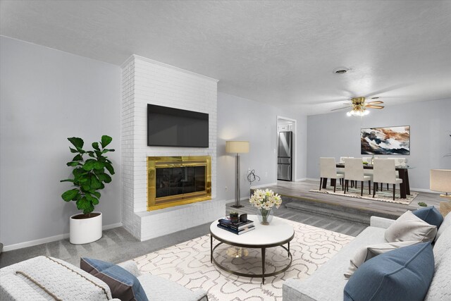 4067 Flintrock Way, Martinez, GA 30907 - living room with a fireplace, a ceiling fan, and a textured ceiling