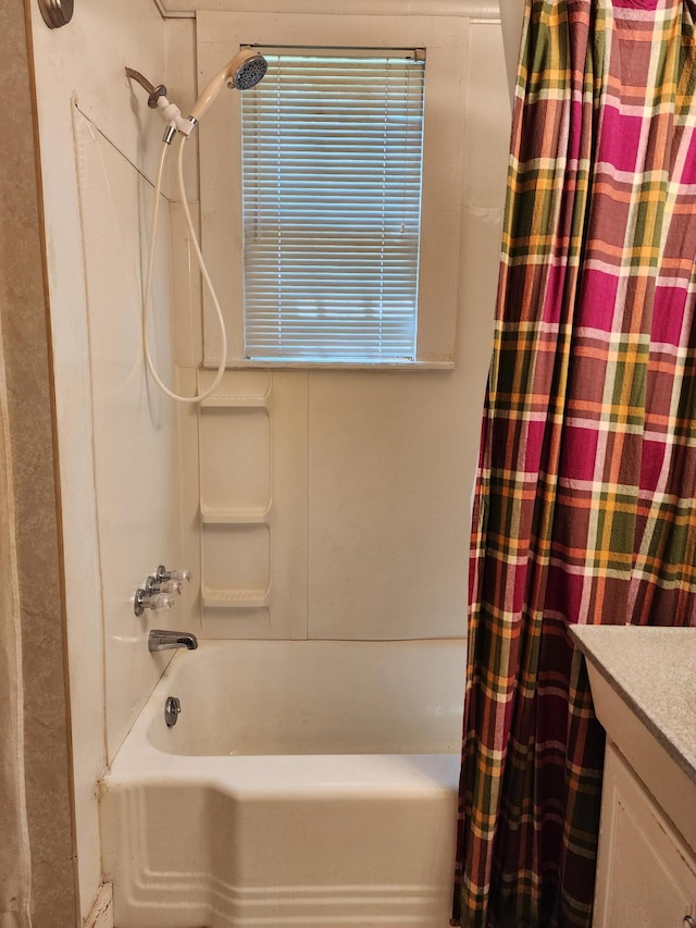 bathroom featuring vanity and shower / bathtub combination with curtain