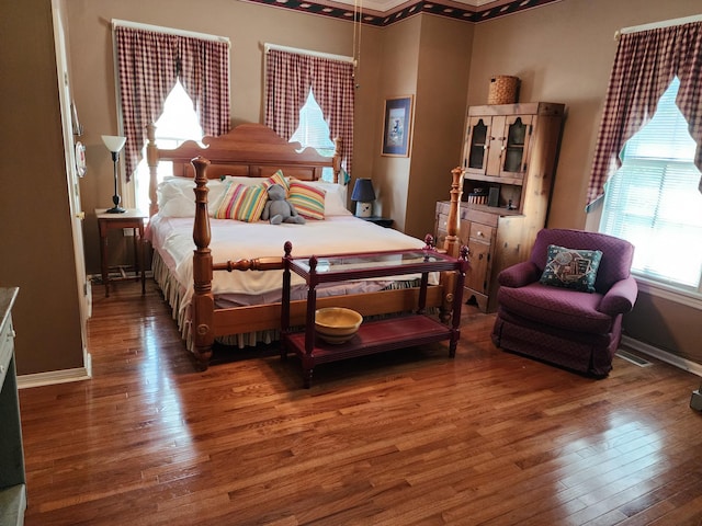 bedroom featuring crown molding and hardwood / wood-style flooring