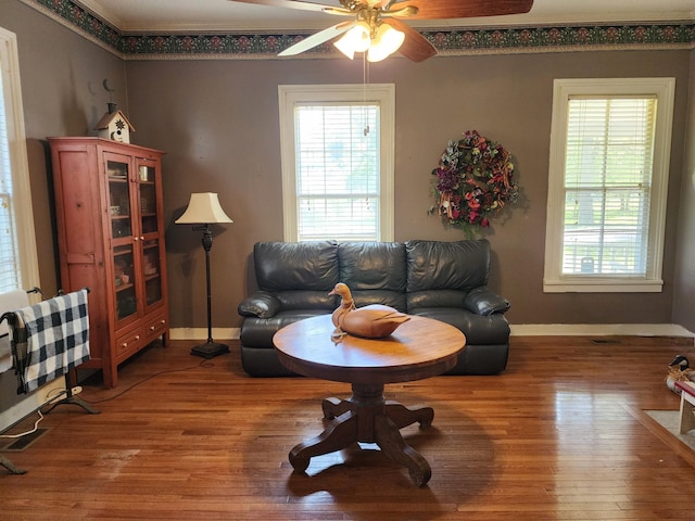 living room featuring ceiling fan, plenty of natural light, and hardwood / wood-style flooring