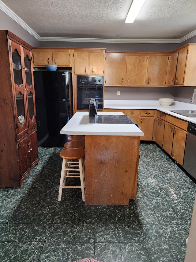 kitchen featuring a textured ceiling, sink, and black appliances