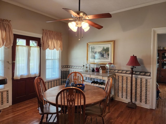 dining area featuring ceiling fan, crown molding, and dark wood-type flooring