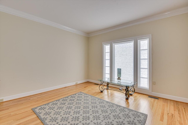 home office featuring ornamental molding, wood finished floors, and baseboards