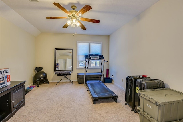 workout area with light colored carpet, ceiling fan, and baseboards