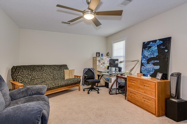 office space featuring ceiling fan, visible vents, and carpet flooring