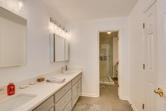 full bath featuring a sink, a shower stall, baseboards, and double vanity