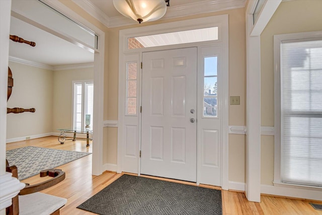 entrance foyer featuring baseboards, light wood-type flooring, visible vents, and crown molding