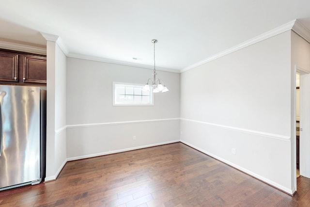 unfurnished dining area featuring an inviting chandelier, dark hardwood / wood-style flooring, and crown molding