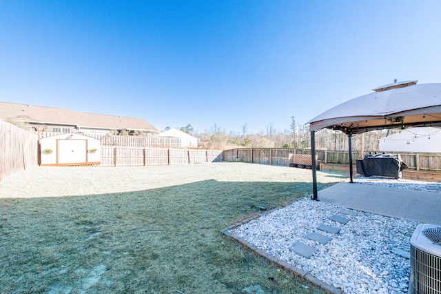 view of yard featuring a gazebo, cooling unit, and a storage unit