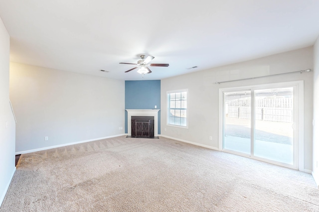 unfurnished living room with ceiling fan and carpet flooring