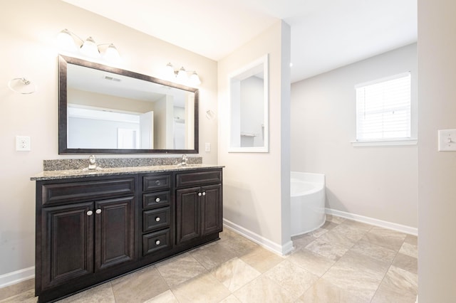 bathroom with a tub to relax in and vanity